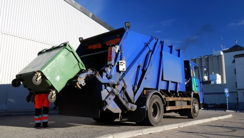 Rubbish removal truck unloading in Norbiton